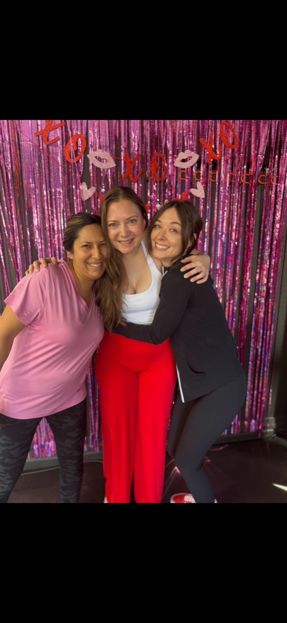 Mel smiling with two Desert Blaze members at a community event